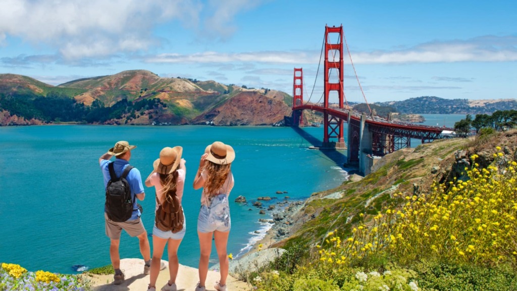 Group of travelers staring at San Francisco bridge